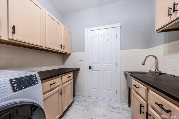 a utility room with sink dryer and washer