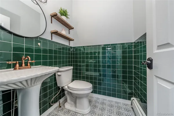 a bathroom with a sink a toilet and a mirror