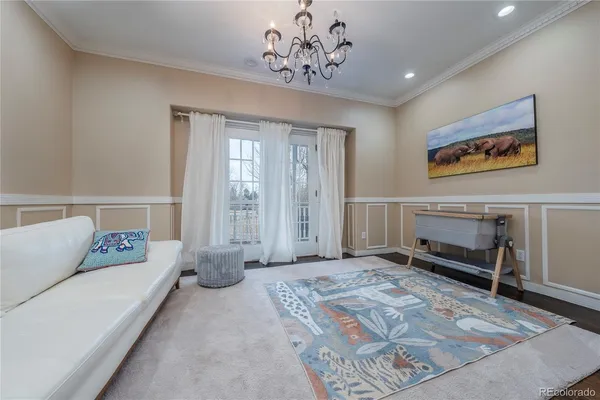 a spacious bedroom with a bed and a chandelier