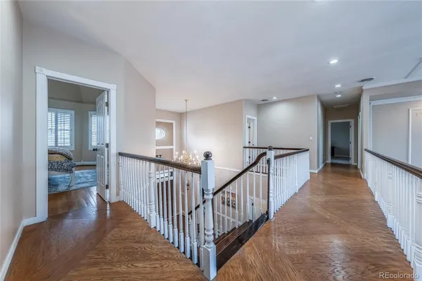 a view of a hallway with a livingroom and stairs