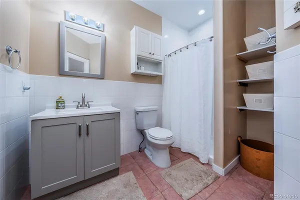 a bathroom with a toilet sink and shower