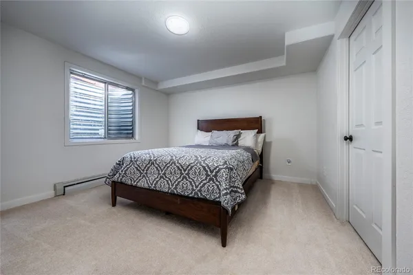 a bedroom with a bed rug and a window