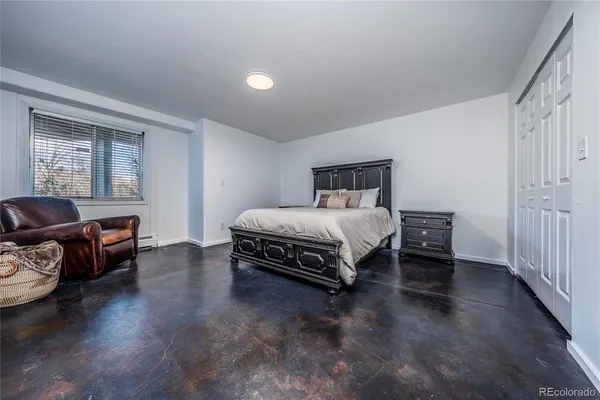 a bedroom with a bed and a couch