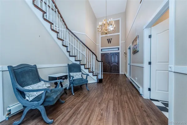 a view of entryway and hall with wooden floor