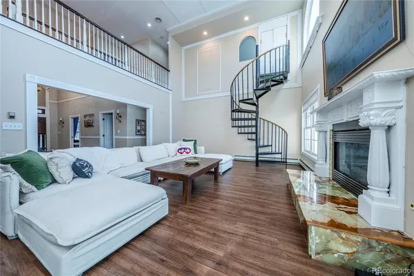 a living room with fireplace furniture and a wooden floor
