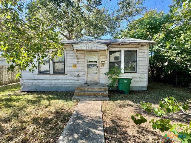 a front view of a house with a yard outdoor seating and yard