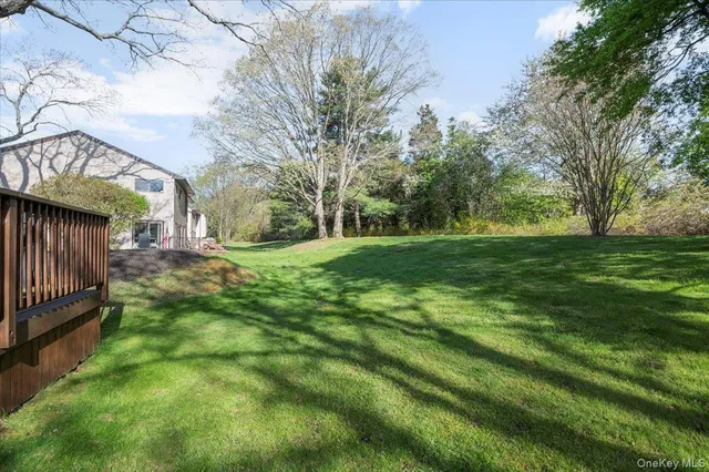 a view of a yard with an tree and wooden fence