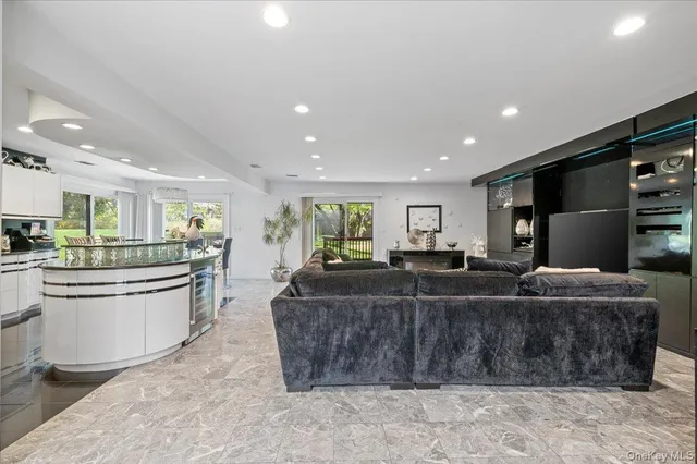 a living room with furniture a dining table and chairs
