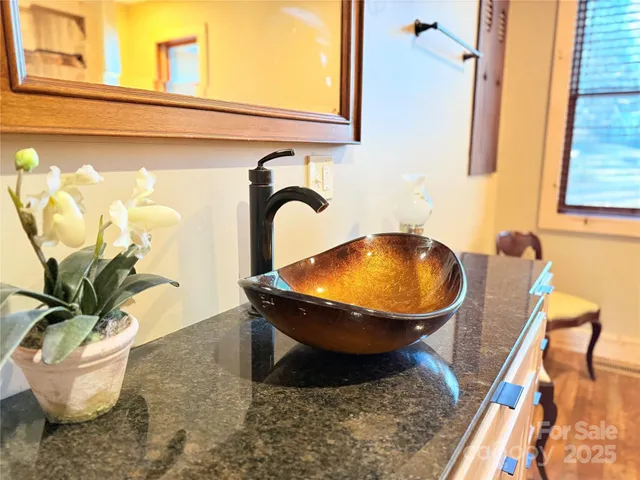 a room with a sink and a mirror