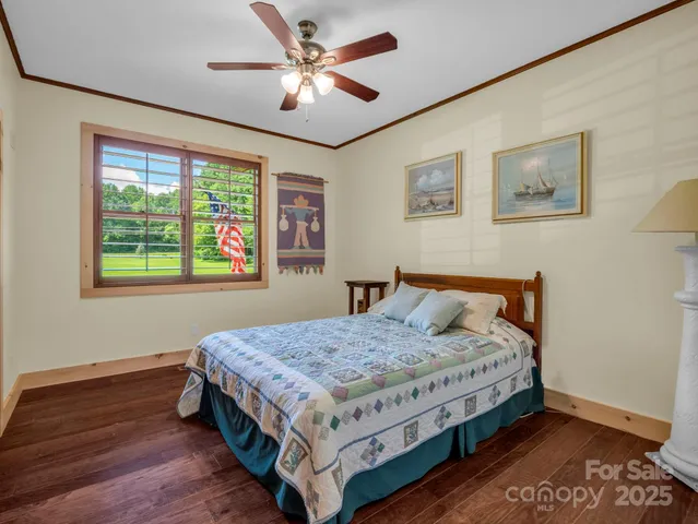 a utility room with wooden floor washer and dryer