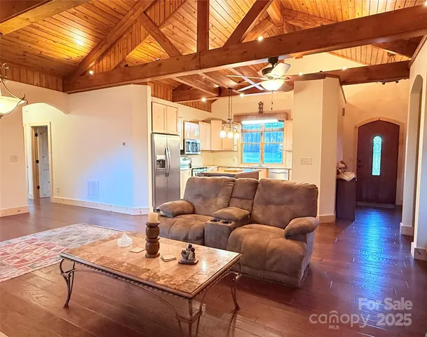 a kitchen with stainless steel appliances granite countertop a refrigerator a sink and a stove