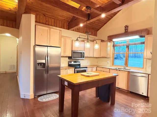 a kitchen with sink cabinets and wooden floor