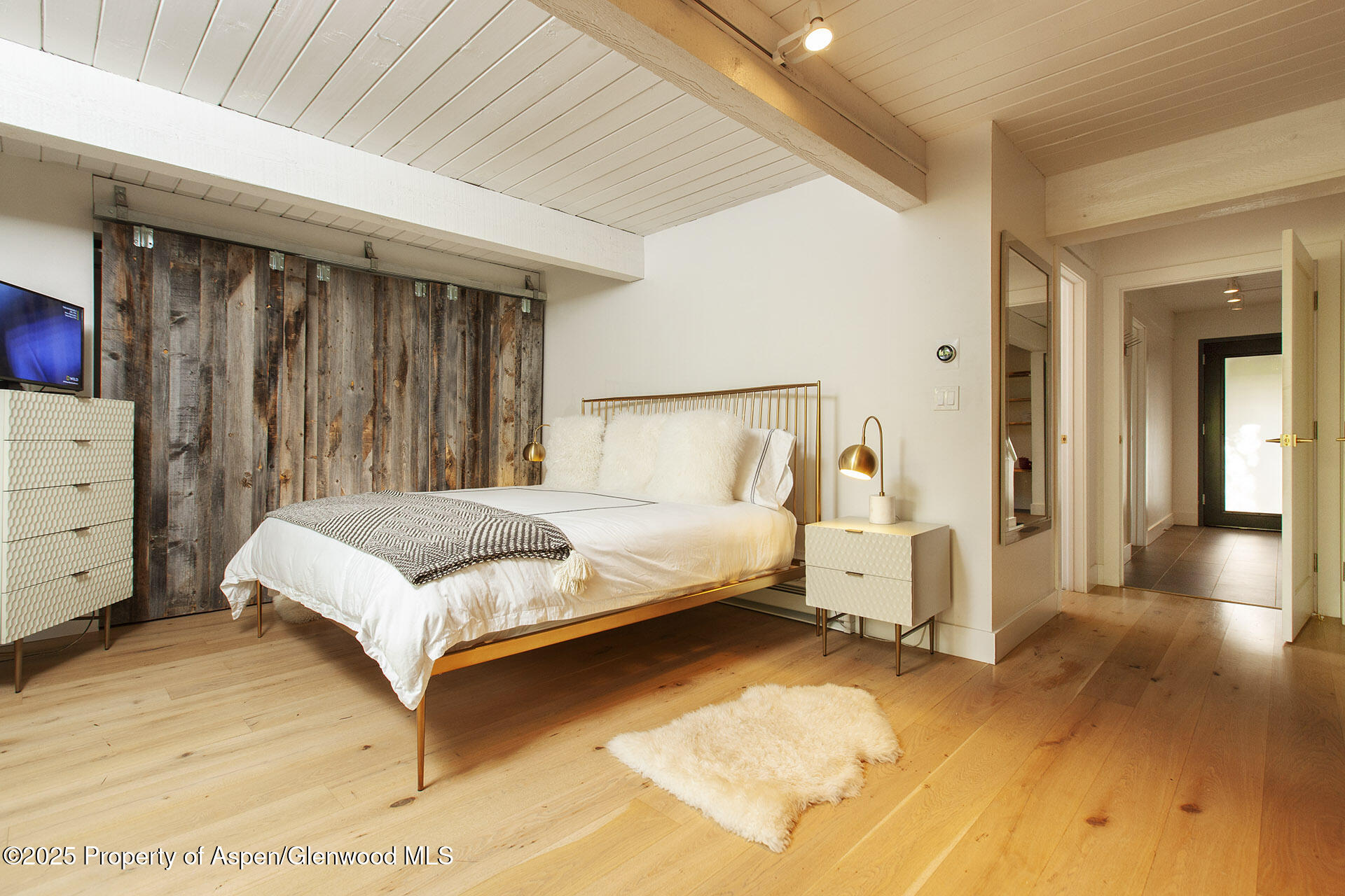 1039 East Cooper Avenue, Unit 16A Aspen, CO 81611 - Photo 12 of 37 a bedroom with a bed and a view of bedroom