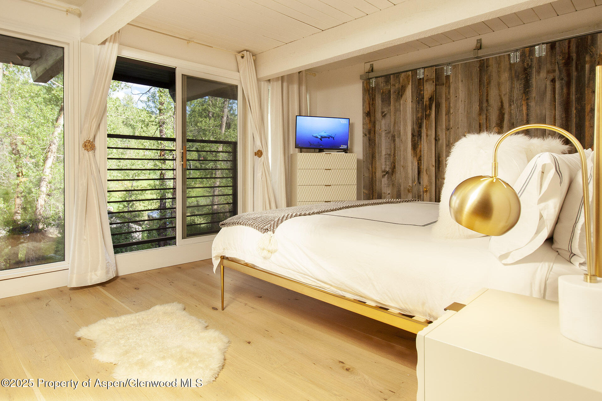 1039 East Cooper Avenue, Unit 16A Aspen, CO 81611 - Photo 13 of 37 a bed room with a bed and a window