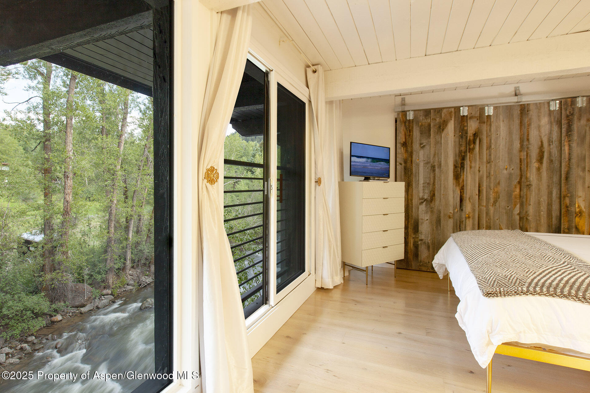 1039 East Cooper Avenue, Unit 16A Aspen, CO 81611 - Photo 14 of 37 a bedroom with a bed and a window