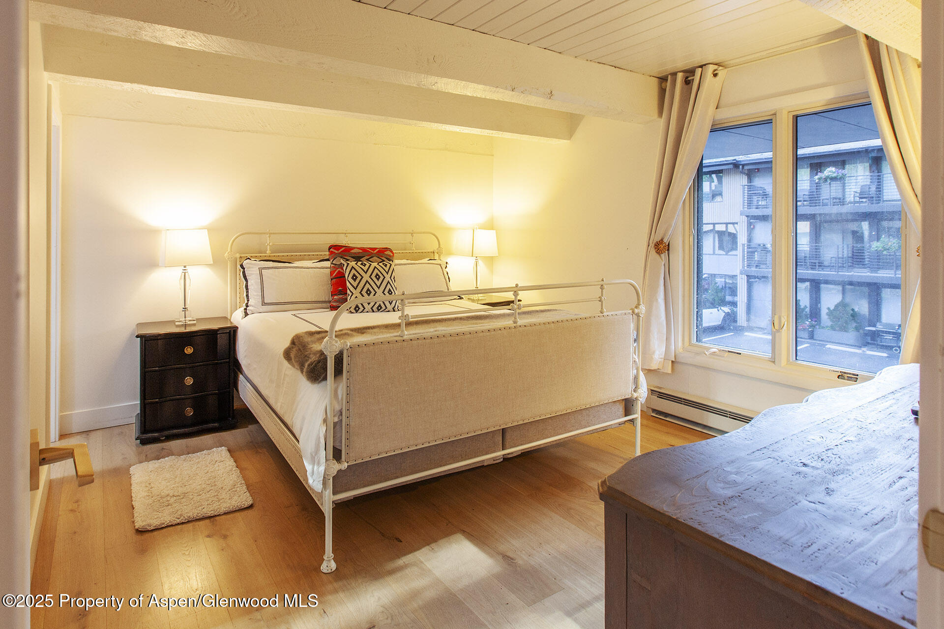 1039 East Cooper Avenue, Unit 16A Aspen, CO 81611 - Photo 15 of 37 a bed room with a bed and a night stand