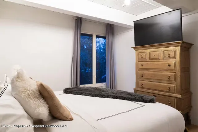 a bedroom with bed and wall painting