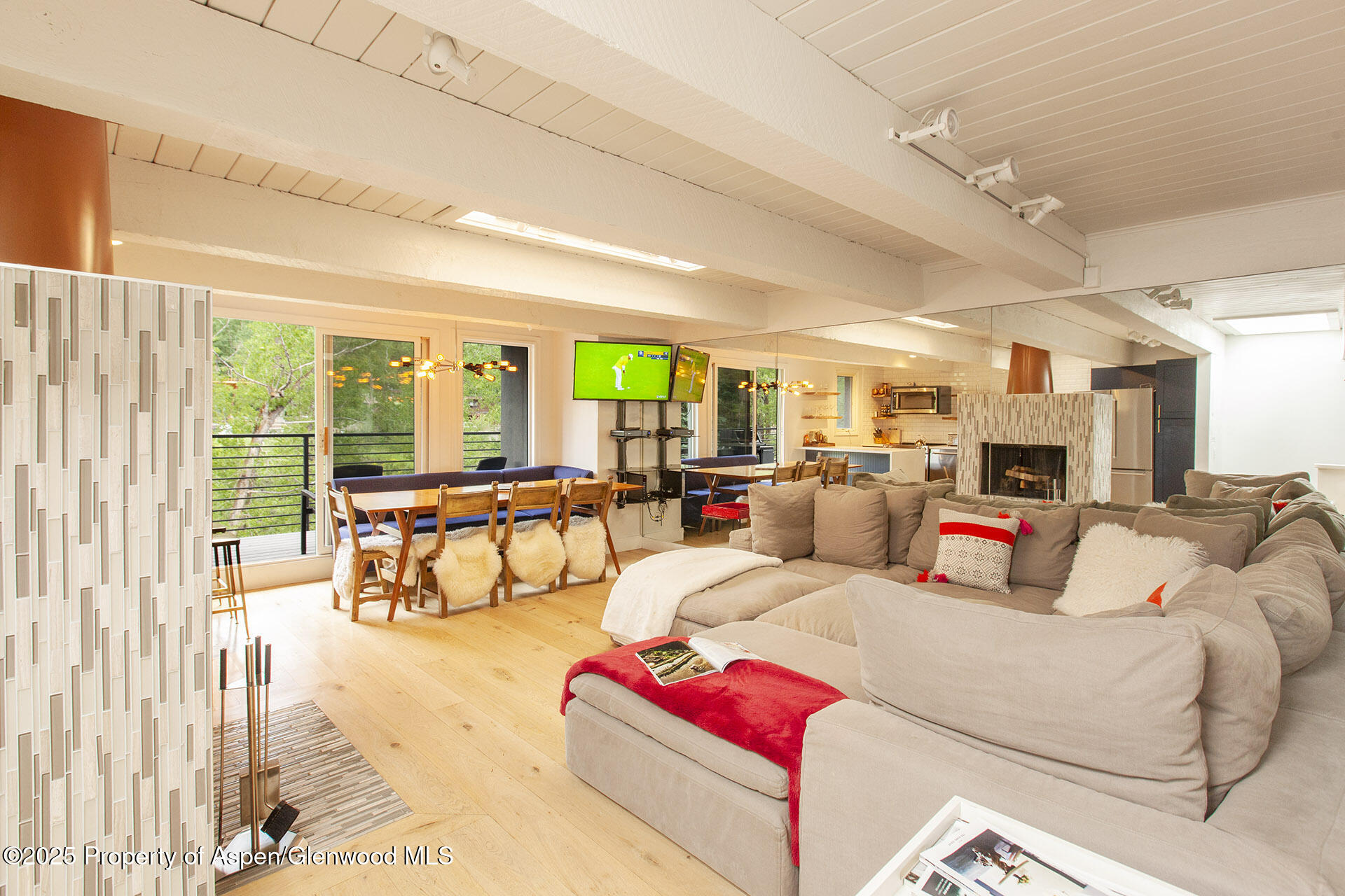 1039 East Cooper Avenue, Unit 16A Aspen, CO 81611 - Photo 2 of 37 a living room with furniture and a large window