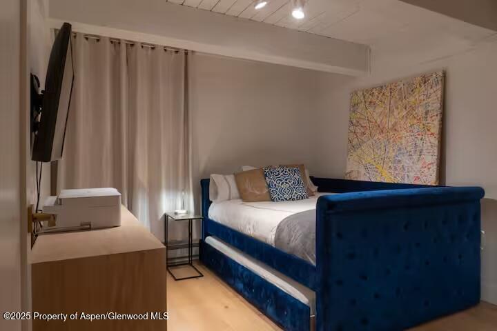 1039 East Cooper Avenue, Unit 16A Aspen, CO 81611 - Photo 21 of 37 a bedroom with a bed and a window