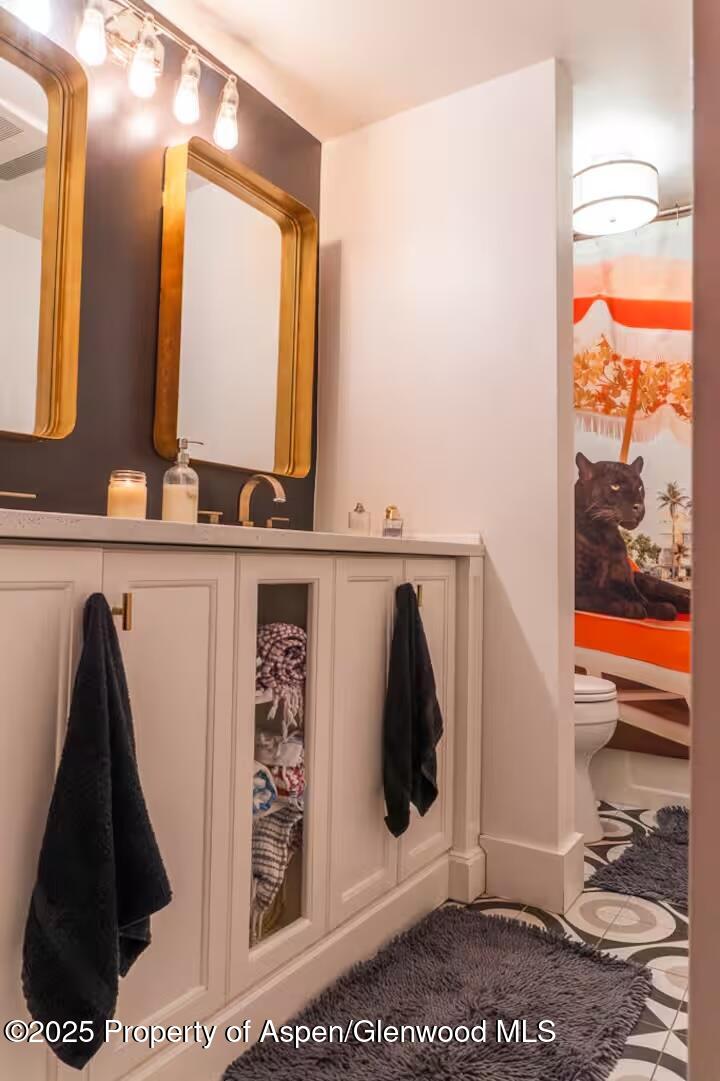 1039 East Cooper Avenue, Unit 16A Aspen, CO 81611 - Photo 23 of 37 a bathroom with a sink and a mirror