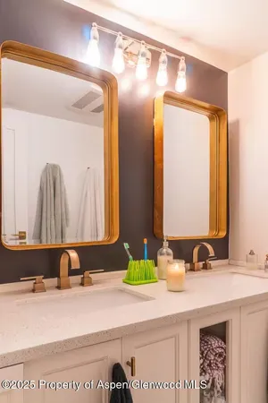 a bathroom with a sink a toilet and shower curtain