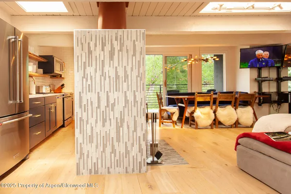 a living room with furniture and a floor to ceiling window