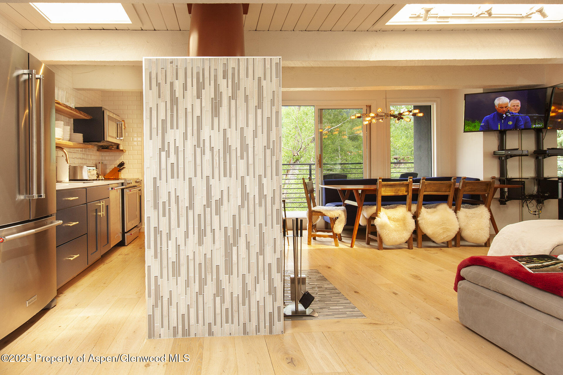 1039 East Cooper Avenue, Unit 16A Aspen, CO 81611 - Photo 3 of 37 a living room with furniture and a floor to ceiling window