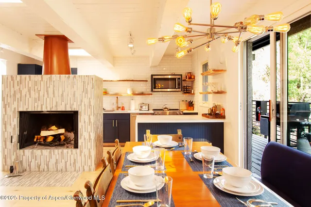 a living room with furniture a fireplace and a table