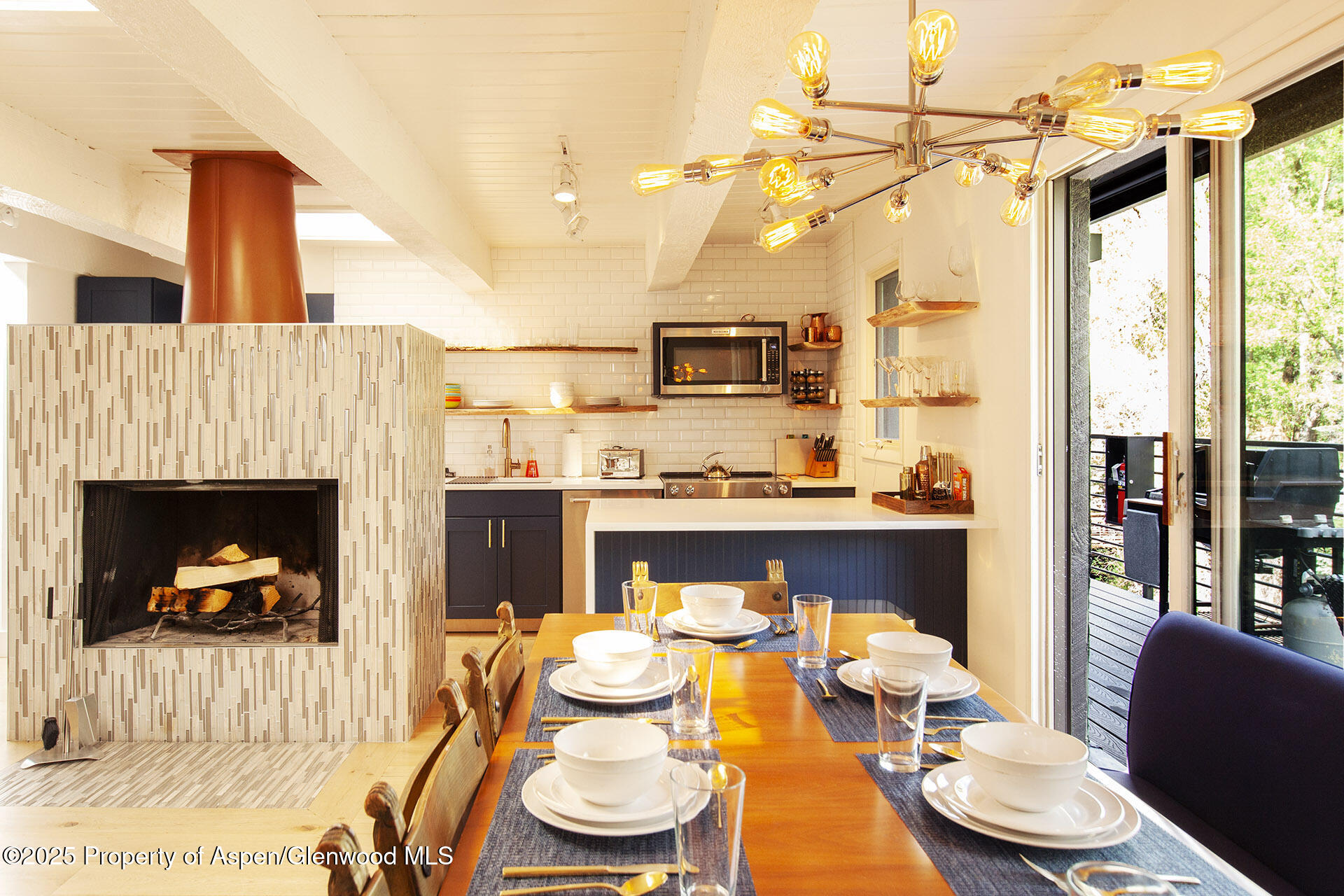 1039 East Cooper Avenue, Unit 16A Aspen, CO 81611 - Photo 4 of 37 a living room with furniture a fireplace and a table