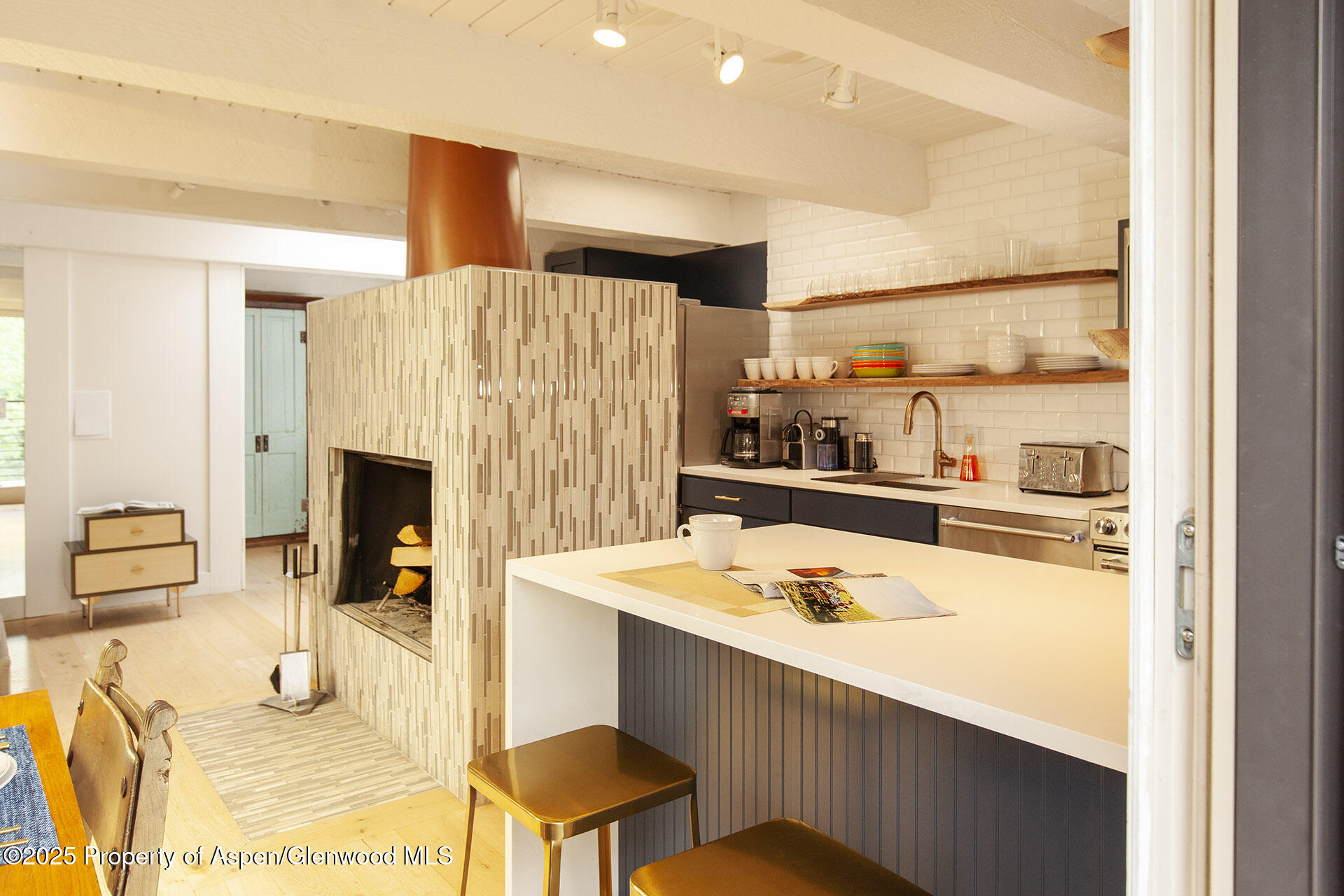 1039 East Cooper Avenue, Unit 16A Aspen, CO 81611 - Photo 6 of 37 a dining table with kitchen view