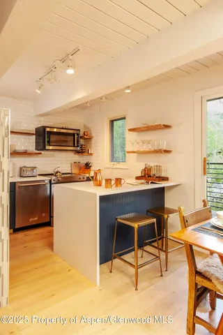 a kitchen with stainless steel appliances kitchen island granite countertop a sink and cabinets