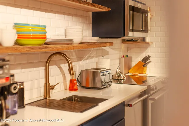 a bathroom with a granite countertop sink and mirror