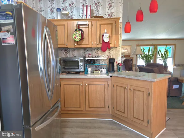 a kitchen with stainless steel appliances granite countertop a refrigerator and a stove