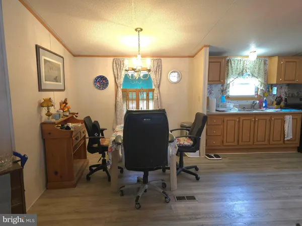 a view of a dining room with furniture and a window