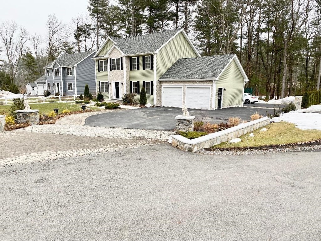 85 Littleton Road Ayer, MA 01432 - Photo 1 of 15 a view of a white house with a big yard and large trees