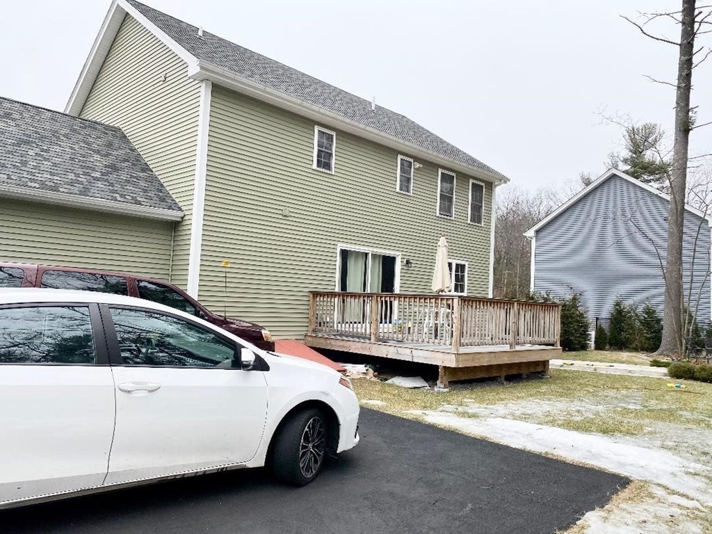 85 Littleton Road Ayer, MA 01432 - Photo 12 of 15 a car parked in front of white house