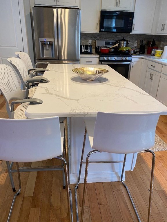 85 Littleton Road Ayer, MA 01432 - Photo 2 of 15 a kitchen with stainless steel appliances wooden cabinets a sink and a stove