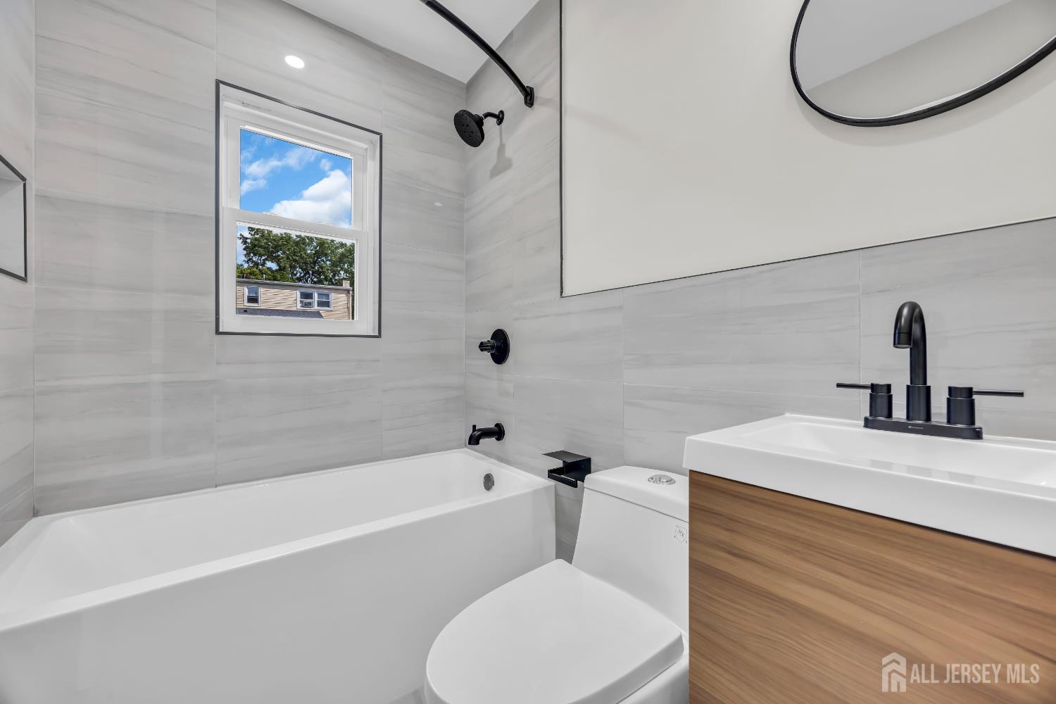 37 North Randolphville Road Piscataway, NJ 08854 - Photo 13 of 31 a bathroom with a sink and a bathtub