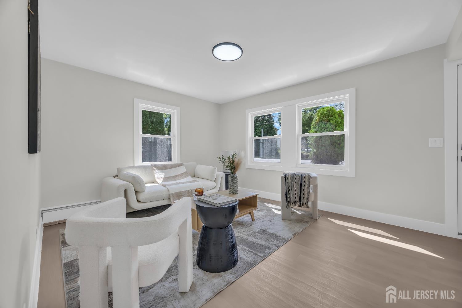 37 North Randolphville Road Piscataway, NJ 08854 - Photo 3 of 31 a living room with couches a table and a large window with garden view