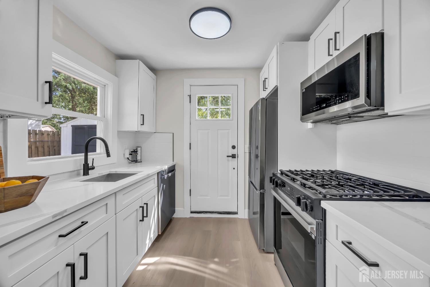 37 North Randolphville Road Piscataway, NJ 08854 - Photo 8 of 31 a kitchen with stainless steel appliances granite countertop a sink stove and microwave