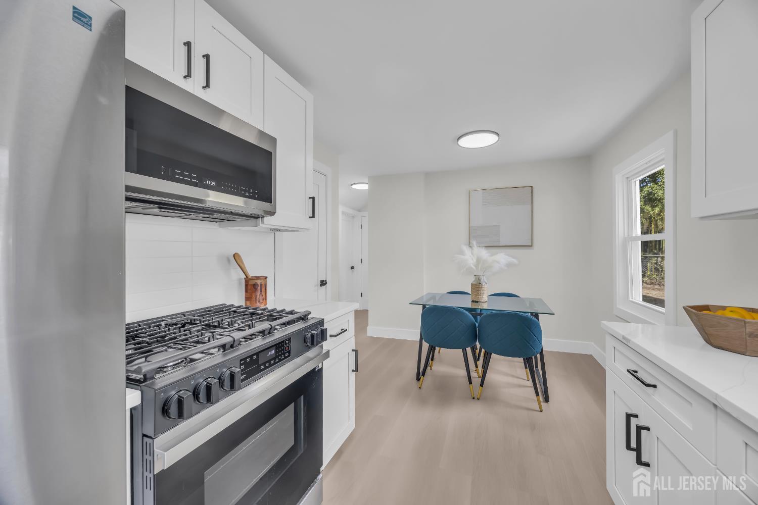 37 North Randolphville Road Piscataway, NJ 08854 - Photo 10 of 31 a kitchen with stainless steel appliances a stove a microwave and white cabinets