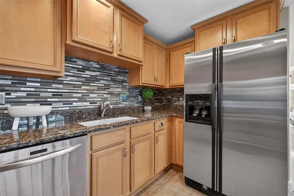 a kitchen with stainless steel appliances granite countertop a sink and cabinets