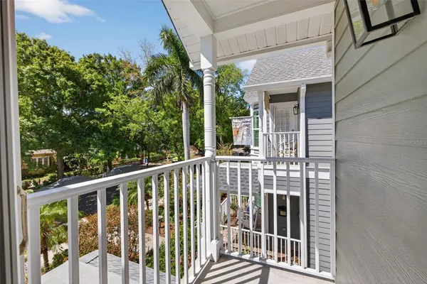 a view of a balcony with wooden floor