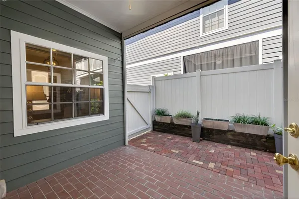 a backyard of a house with outdoor seating