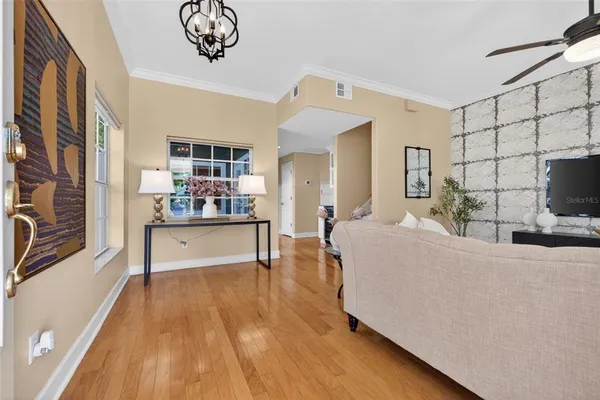 a living room with stainless steel appliances kitchen island granite countertop furniture and a flat screen tv