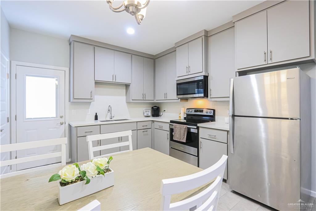 913 West Sunset Valley Street Mission, TX 78573 - Photo 11 of 24 a kitchen with stainless steel appliances granite countertop a refrigerator sink and stove