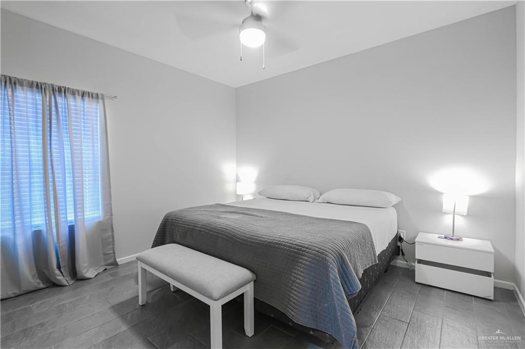913 West Sunset Valley Street Mission, TX 78573 - Photo 16 of 24 a bedroom with a bed and a lamp
