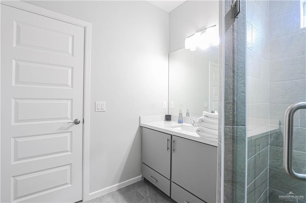 913 West Sunset Valley Street Mission, TX 78573 - Photo 20 of 24 a bathroom with a double vanity sink a toilet and a mirror