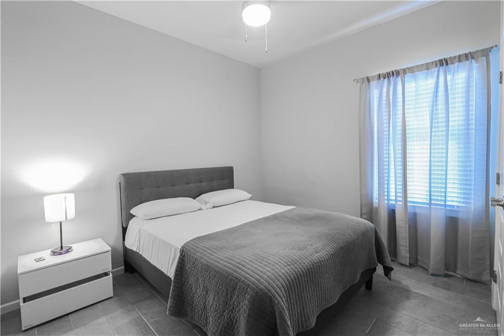 913 West Sunset Valley Street Mission, TX 78573 - Photo 22 of 24 a bedroom with a bed and a window