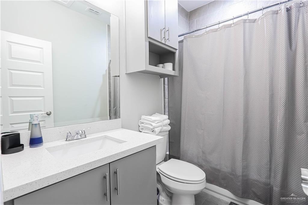 913 West Sunset Valley Street Mission, TX 78573 - Photo 23 of 24 a bathroom with a sink a toilet and shower